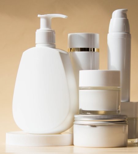 Set of cosmetic bottle on pale beige background, mockup. Health care concept.